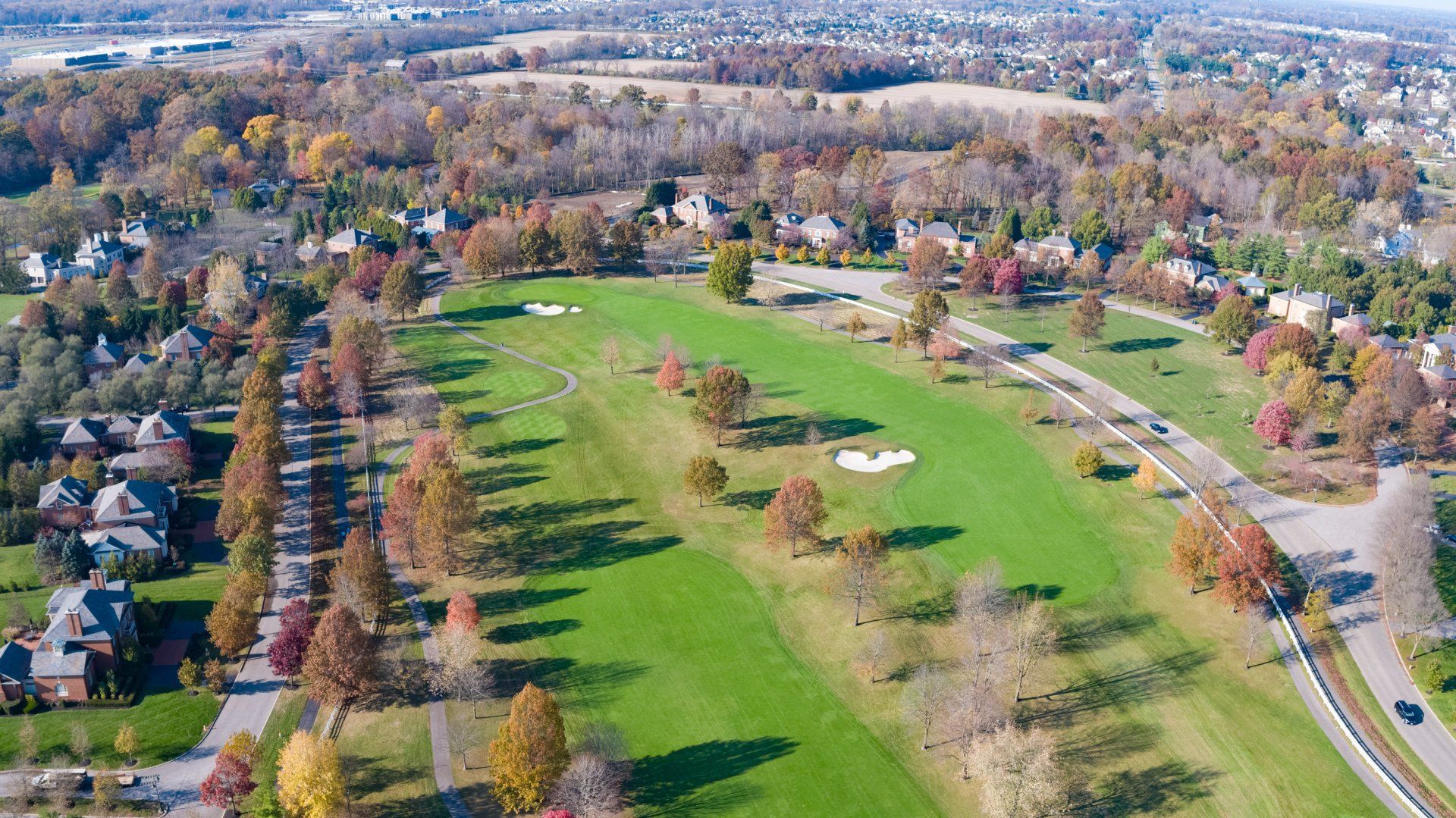 An aerial view of a golf course in a residential area