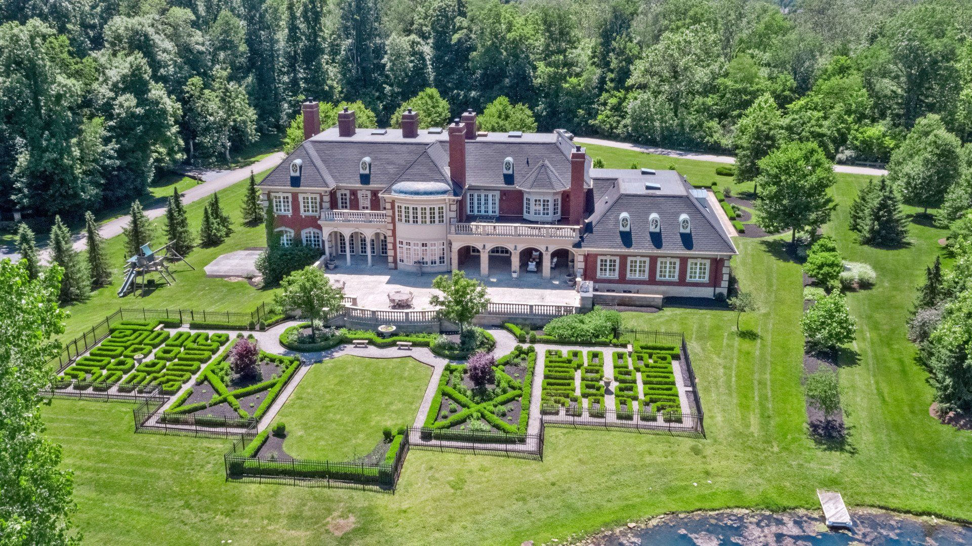 An aerial view of a large house surrounded by trees