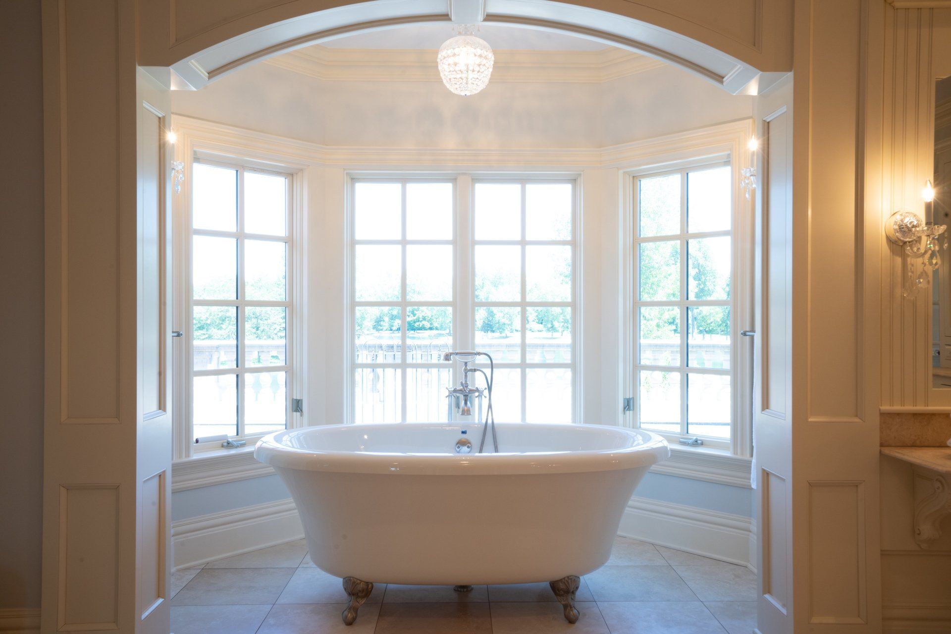 A bathtub in a bathroom with a lot of windows