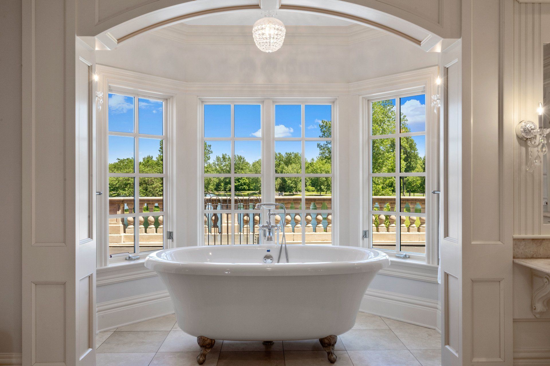 A bathtub in a bathroom with a large window