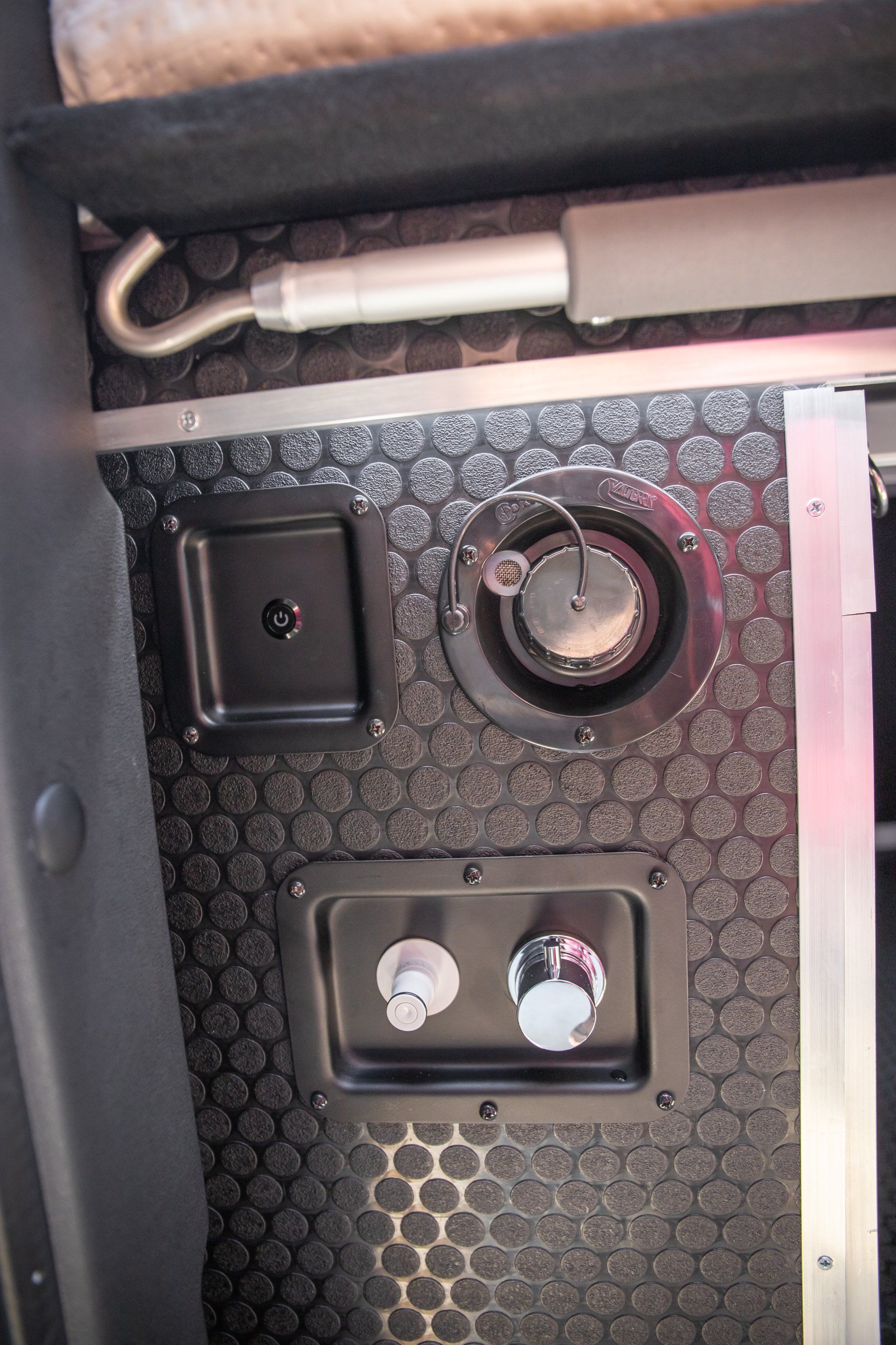 a black wall with a few buttons on it