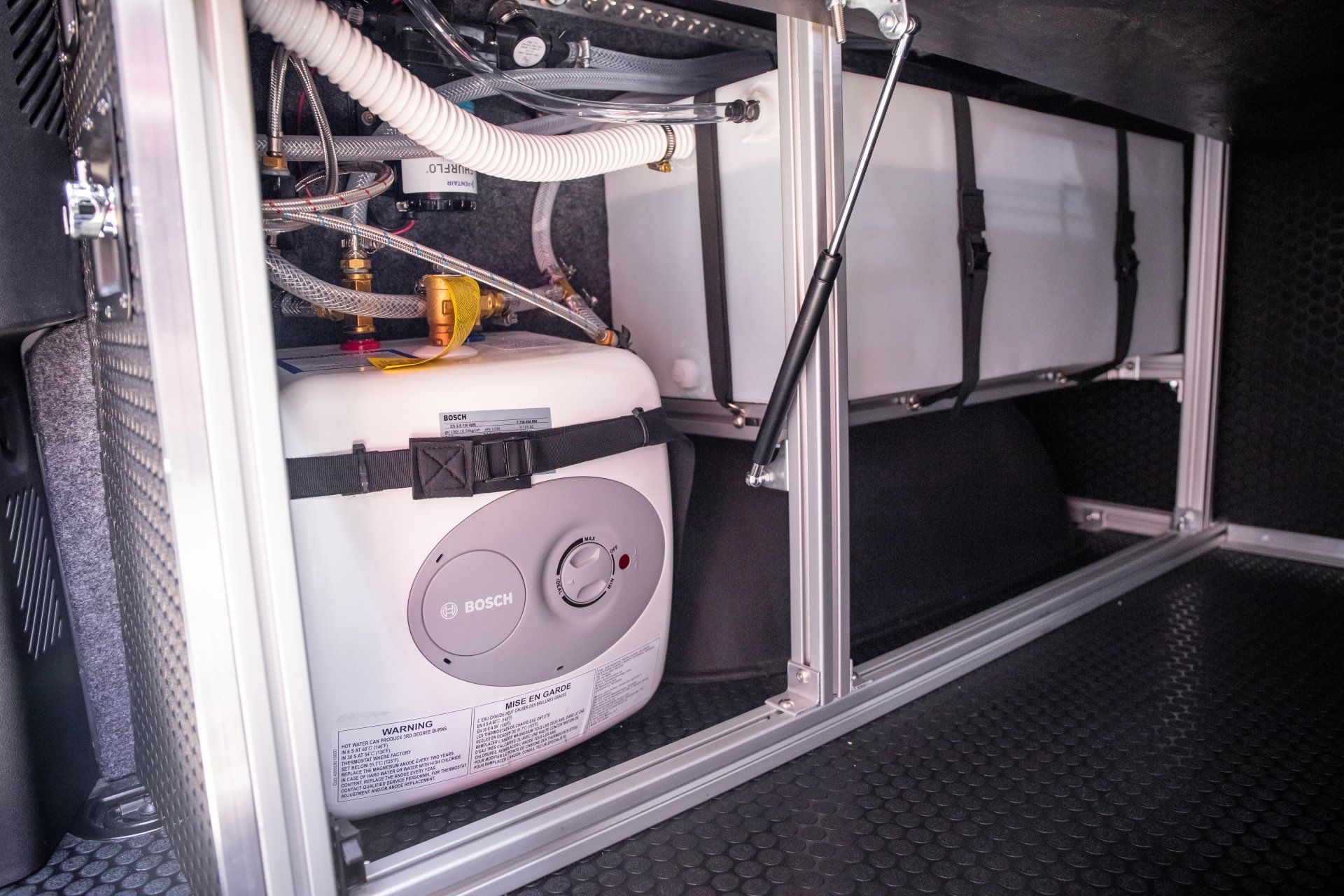a water heater is sitting in the back of a van .