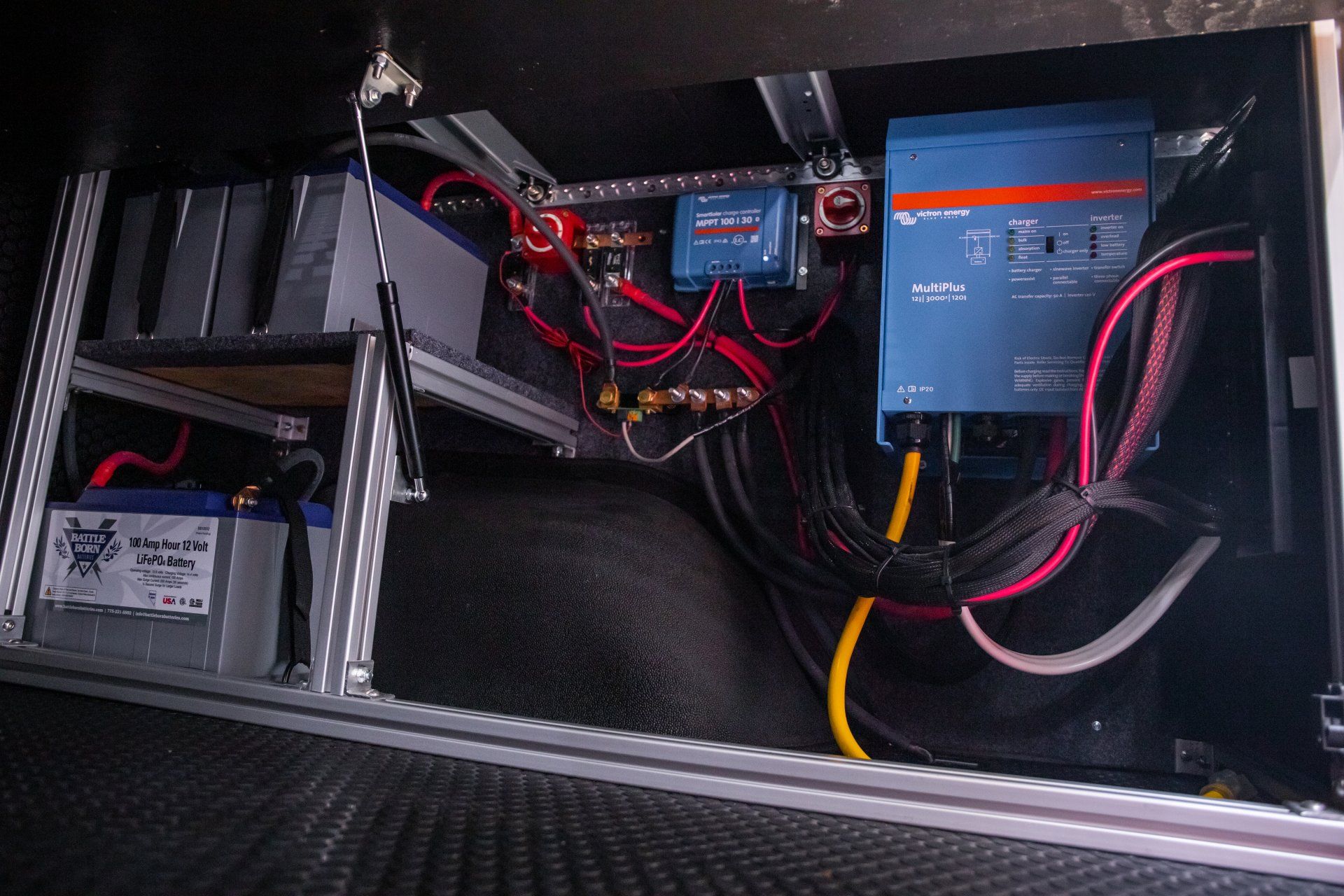 the inside of a vehicle with a lot of wires and batteries