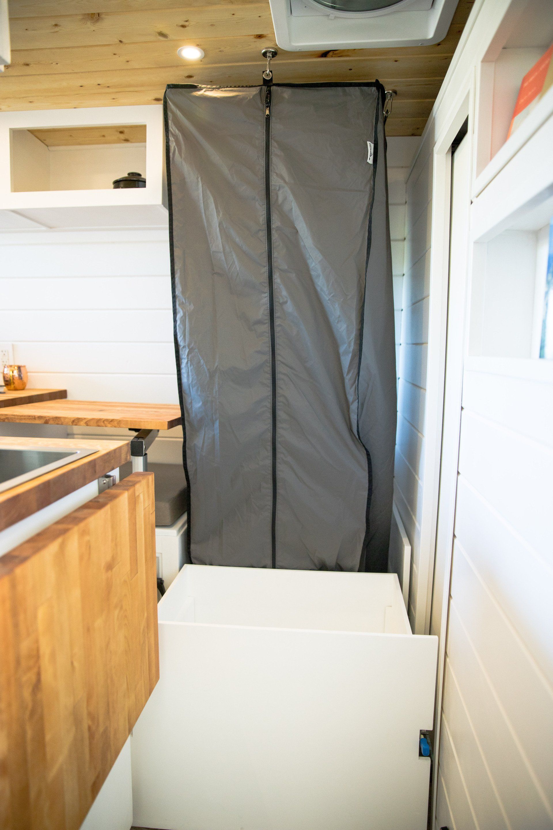 a kitchen with a gray door and a white refrigerator .