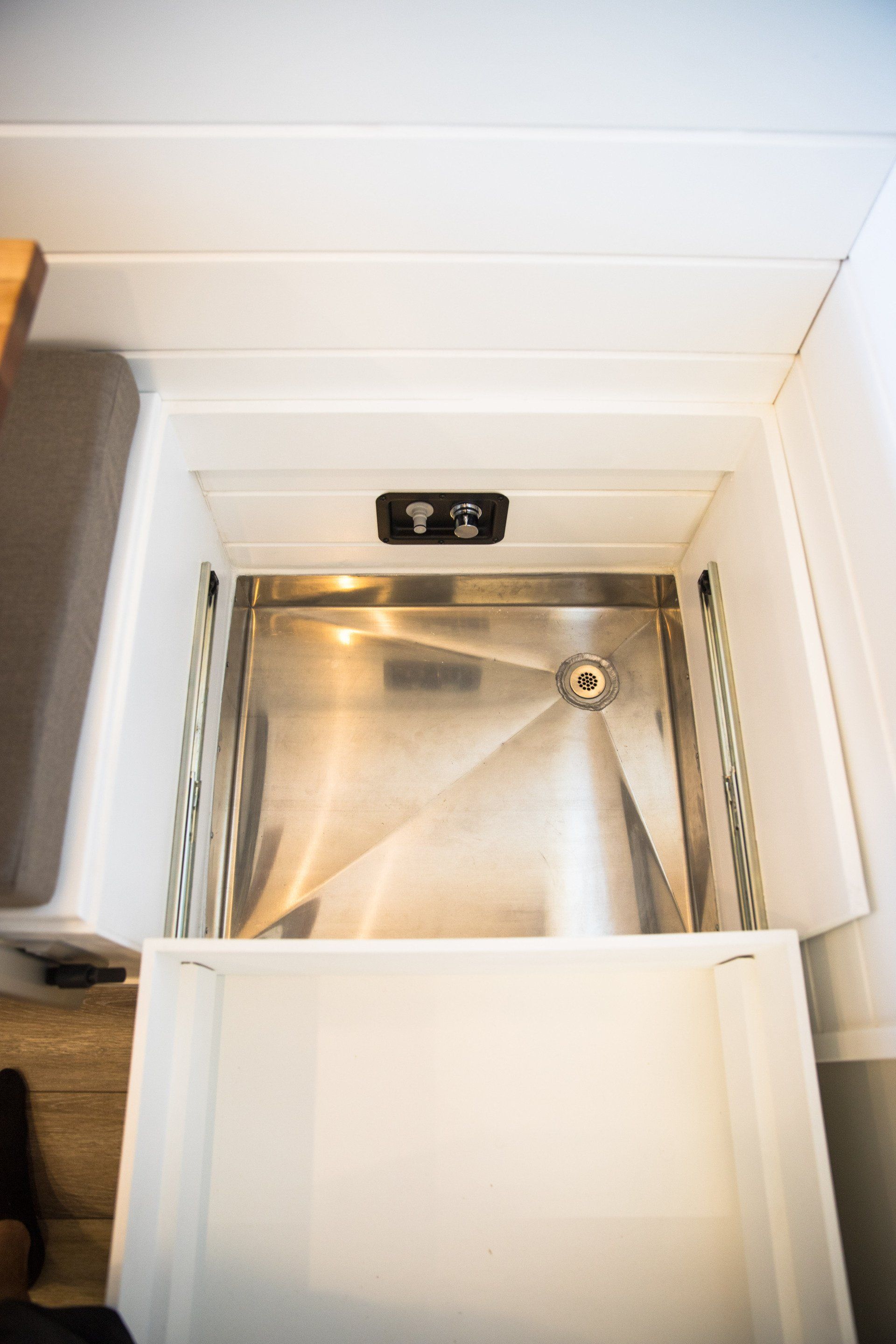a stainless steel sink in a drawer in a kitchen .