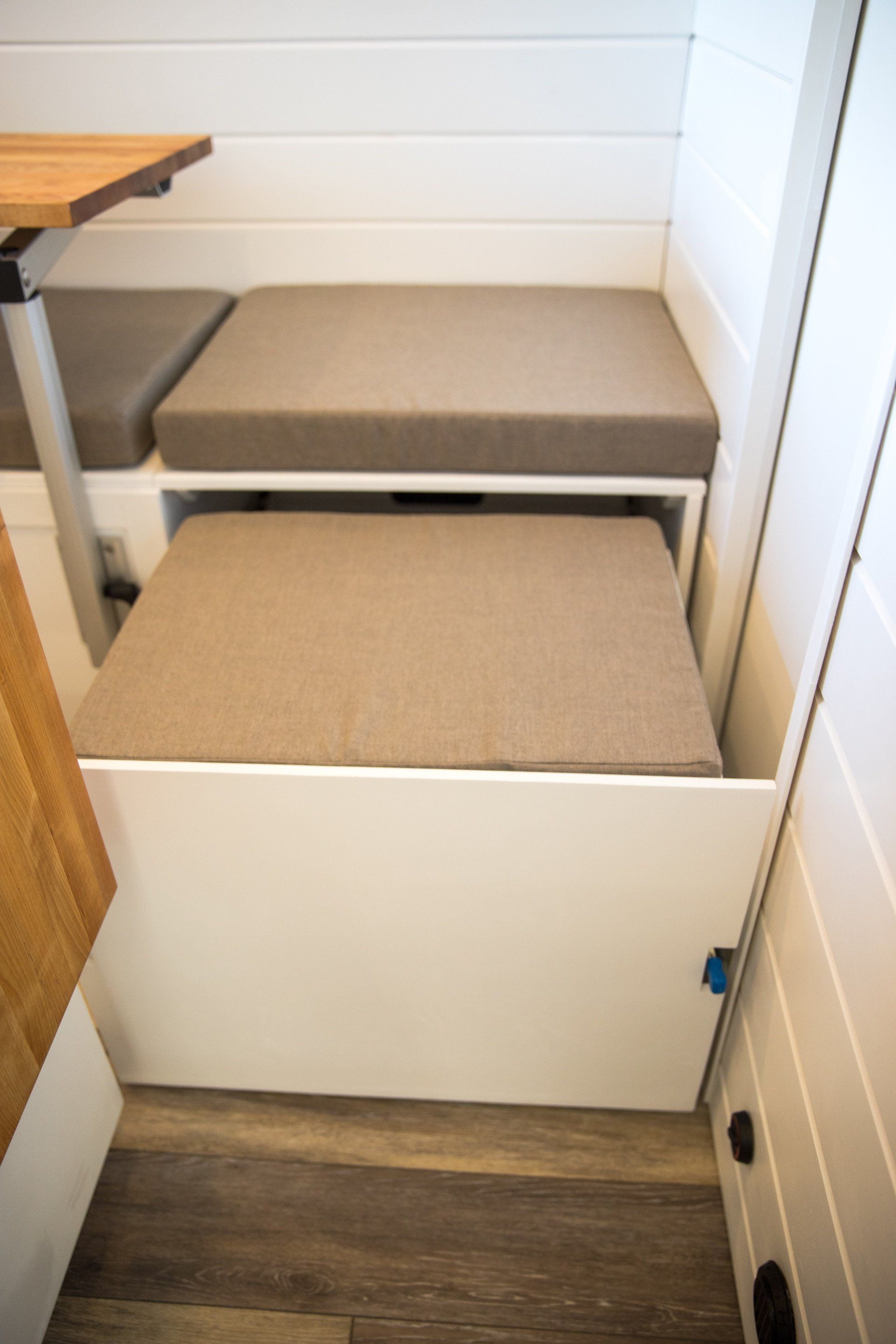 a white box with a cushion on top of it in a room .