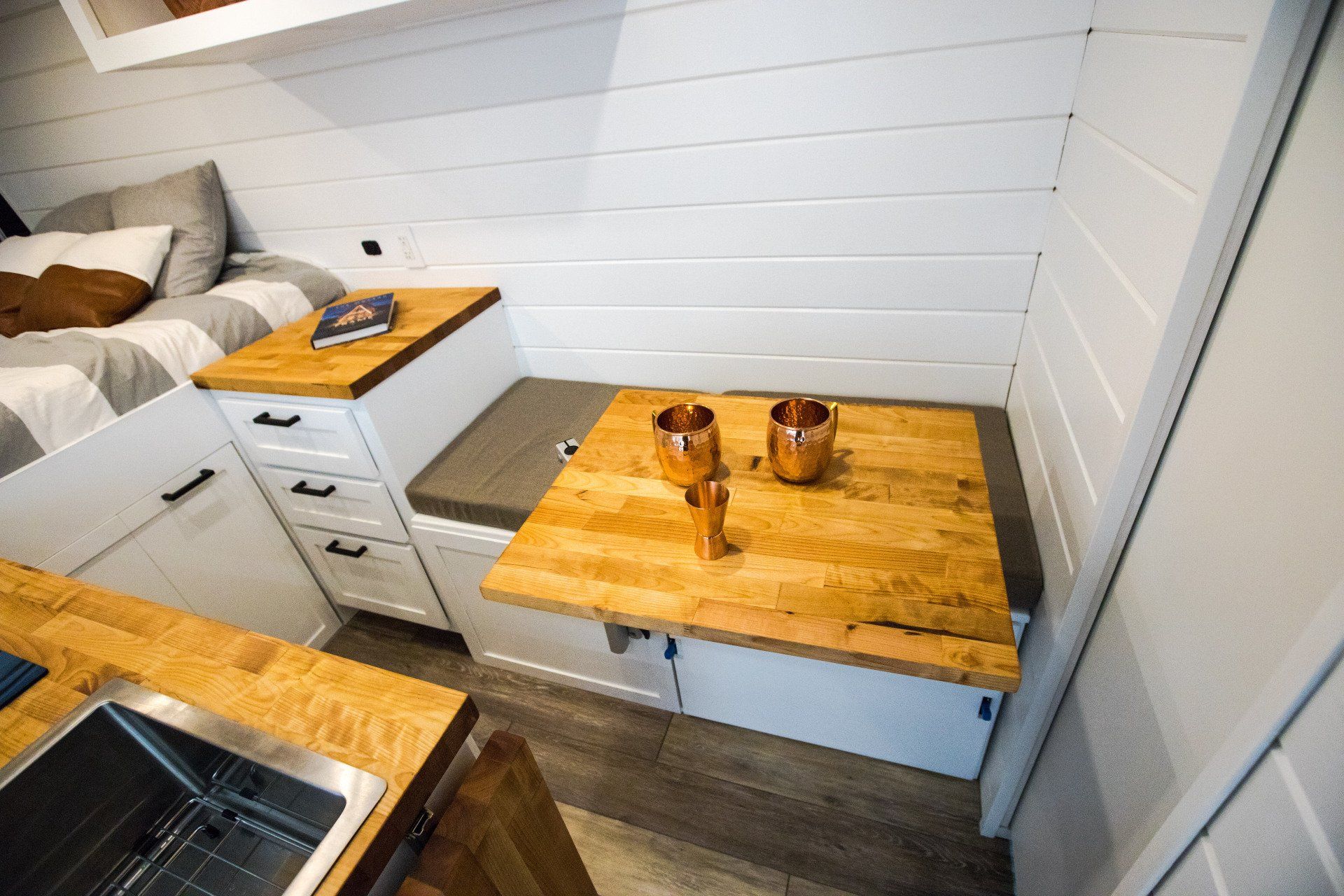 a kitchen with a wooden table and a sink .