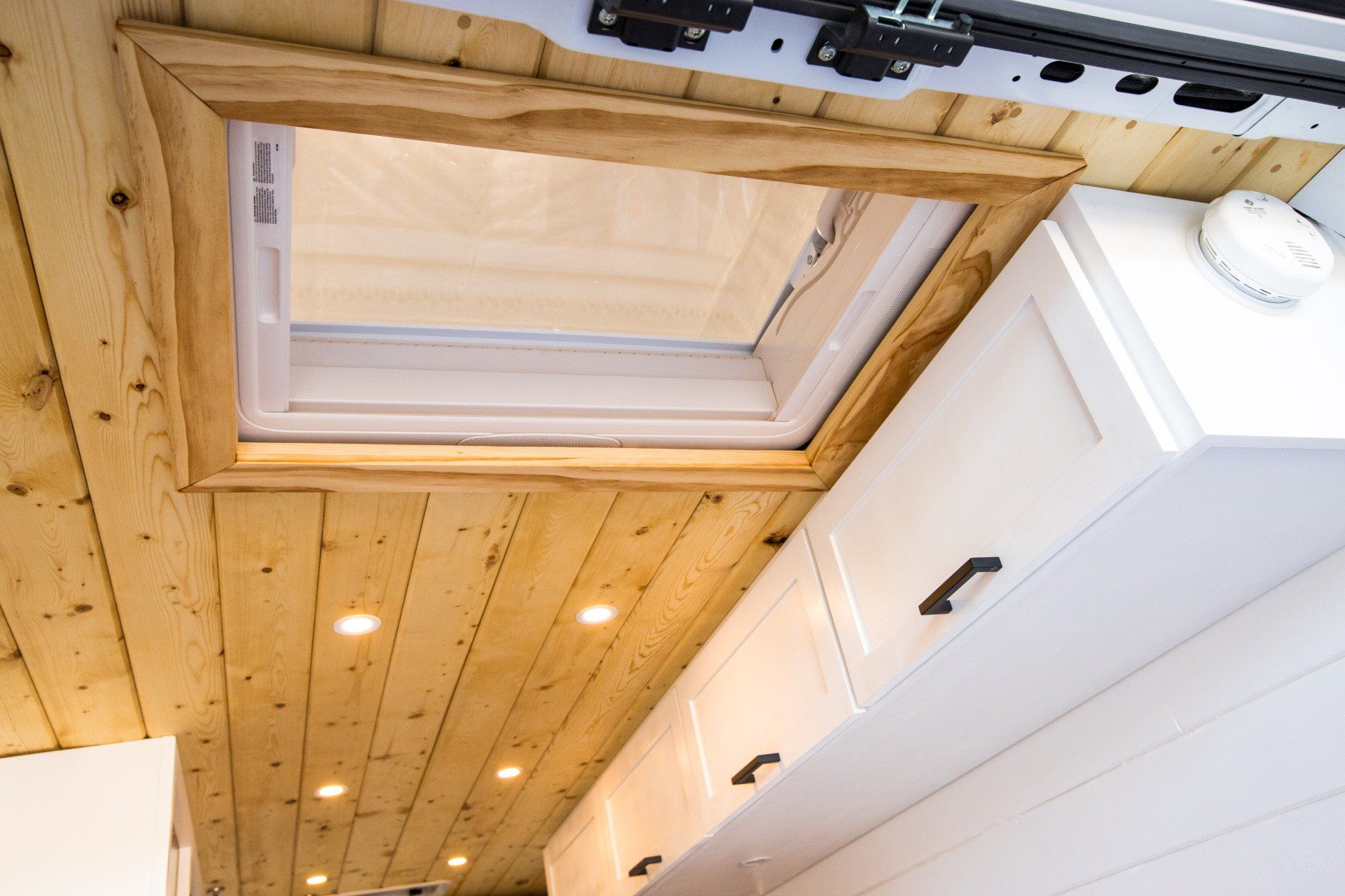 there is a skylight in the ceiling of a van .