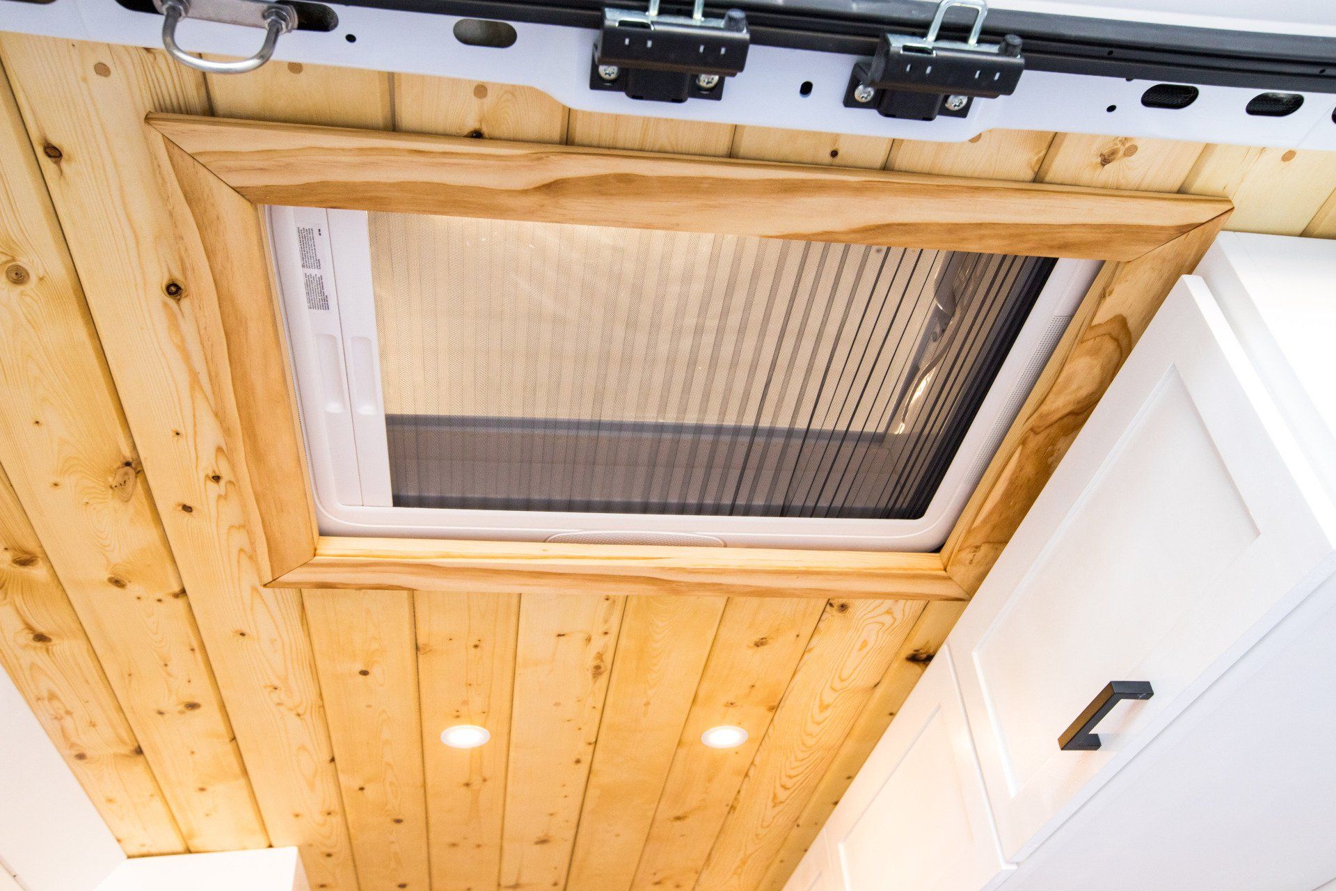 a wooden ceiling with a window in it