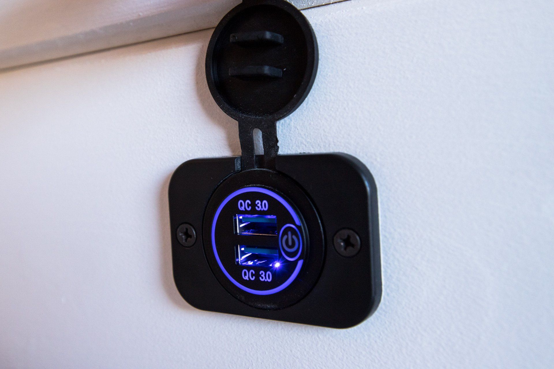 a close up of a charger on a white wall .