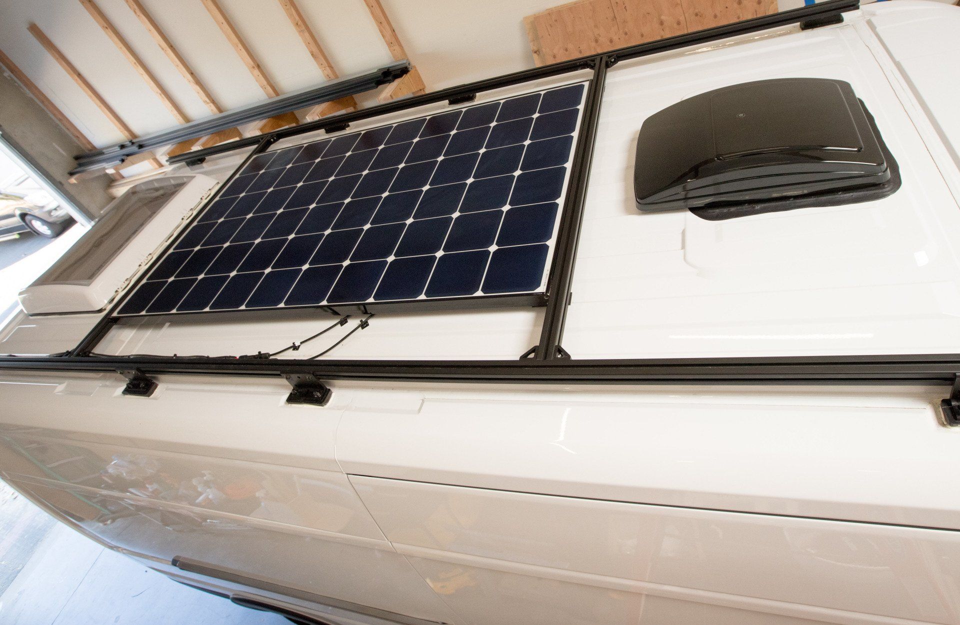 a solar panel is mounted to the roof of a vehicle .