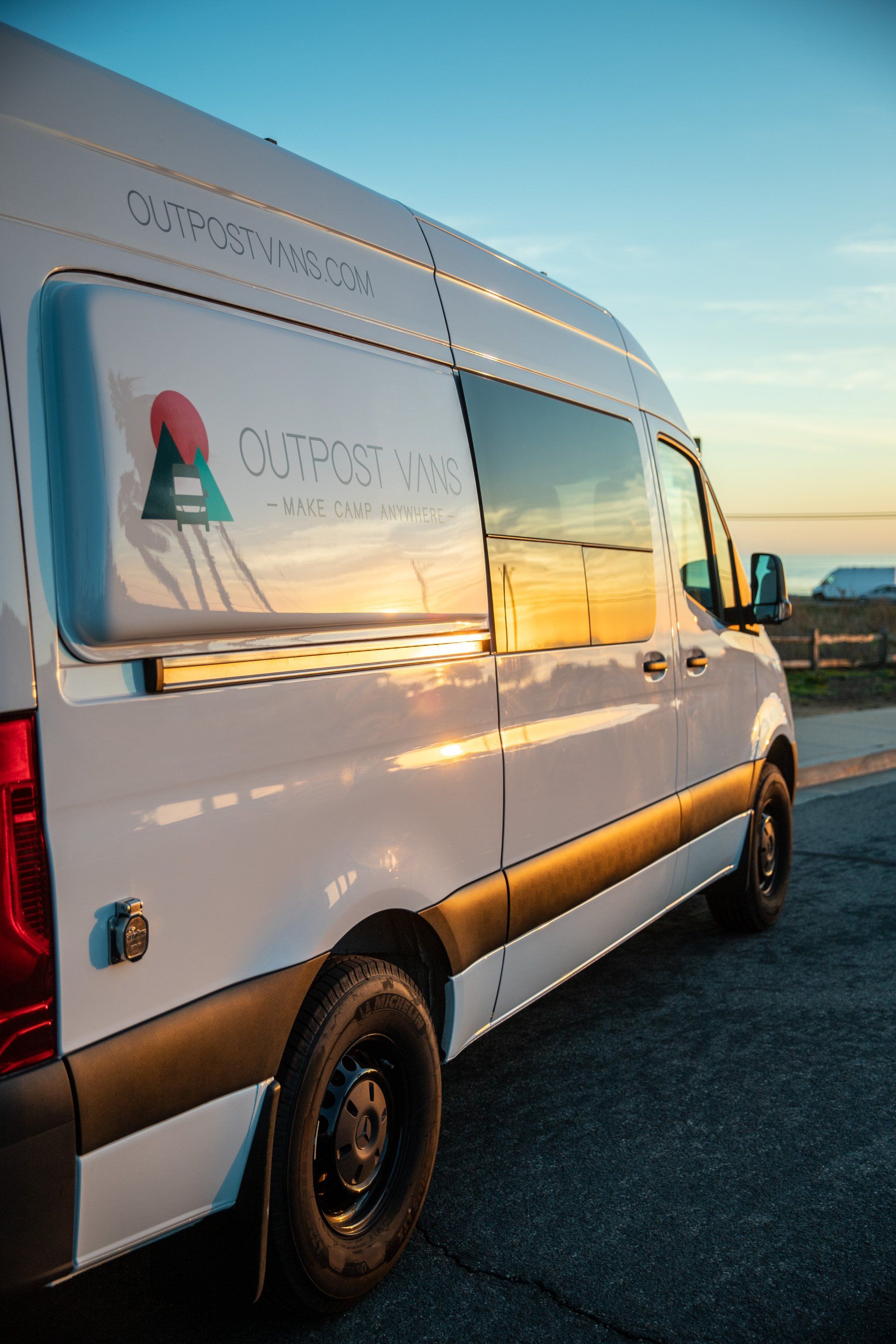 a white van is parked on the side of the road .
