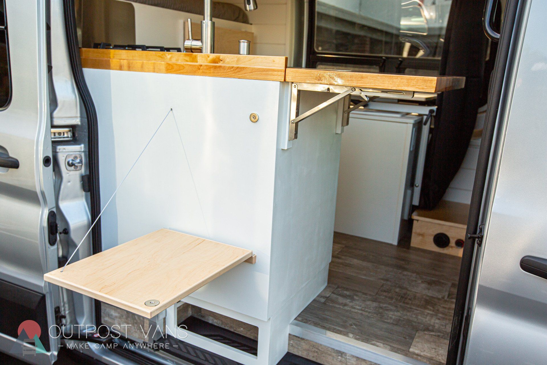a van with a wooden table in the back of it .