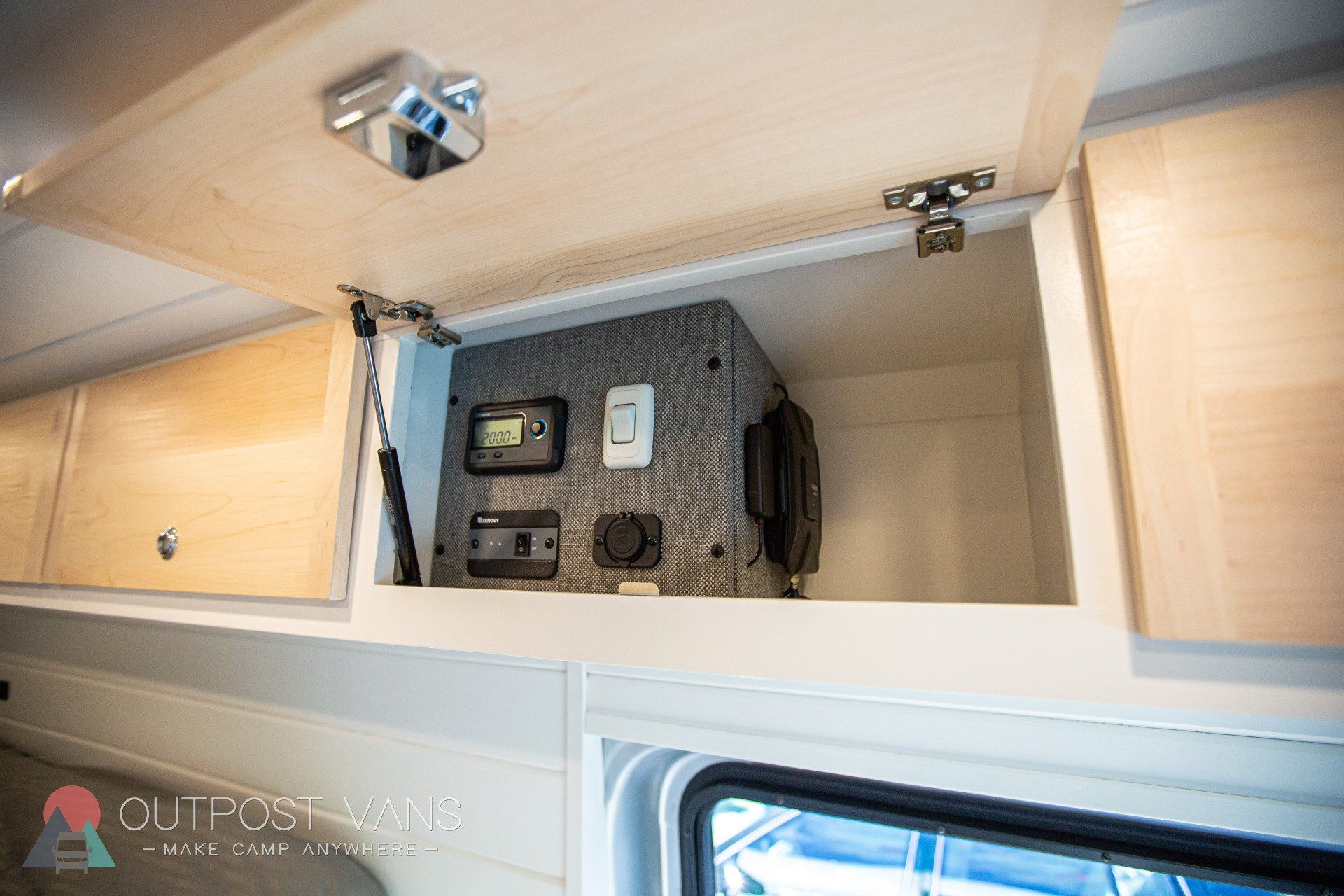 a box is sitting in the ceiling of a van .