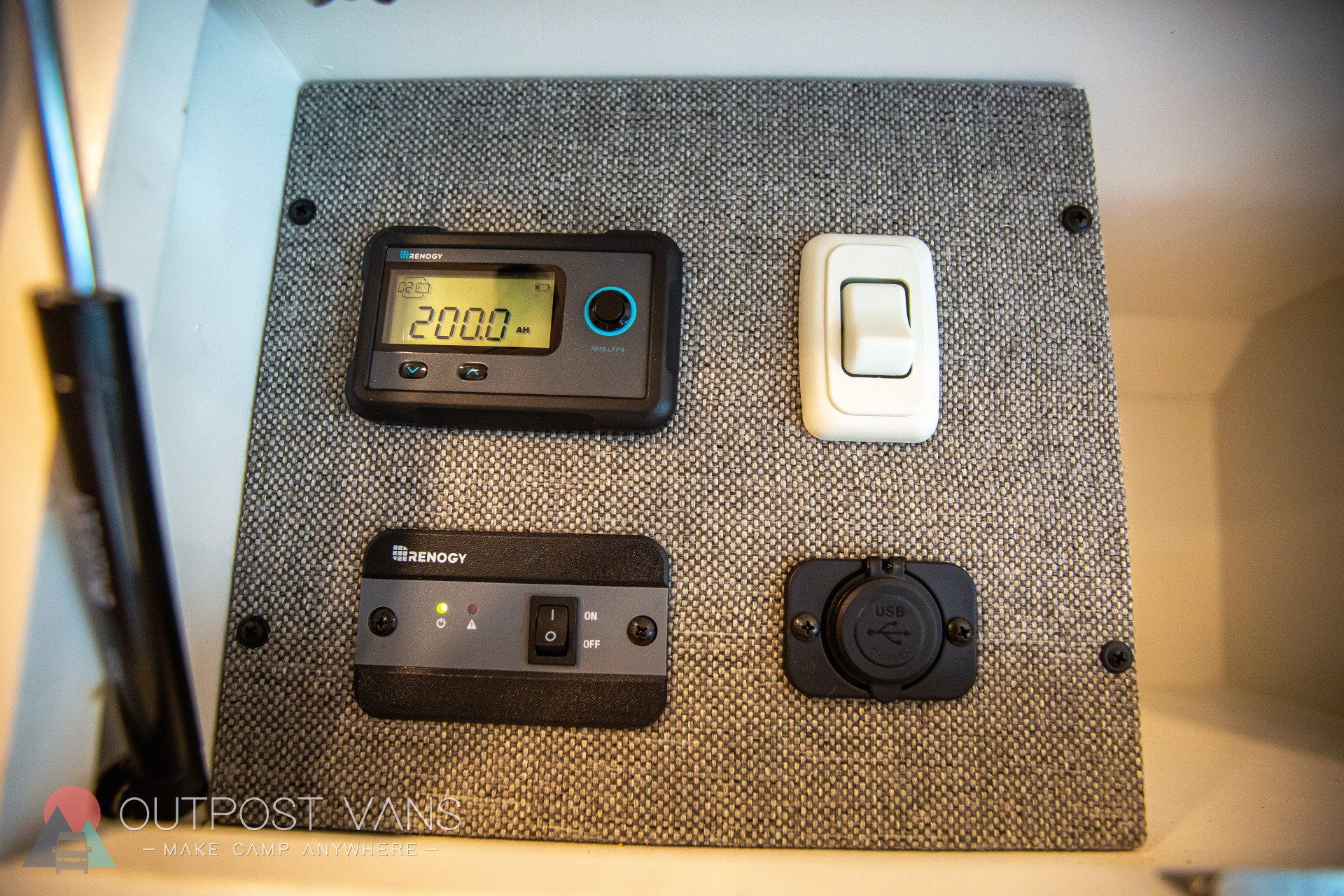 a panel with a clock , a switch , and a charger on it .