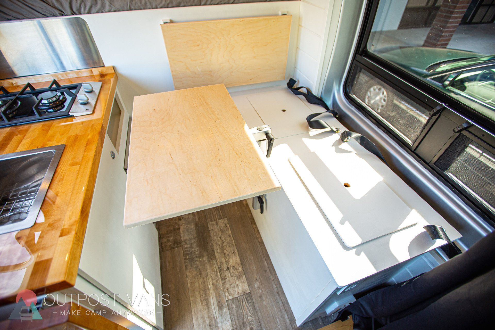 a kitchen with a table that can be pulled out of the wall .