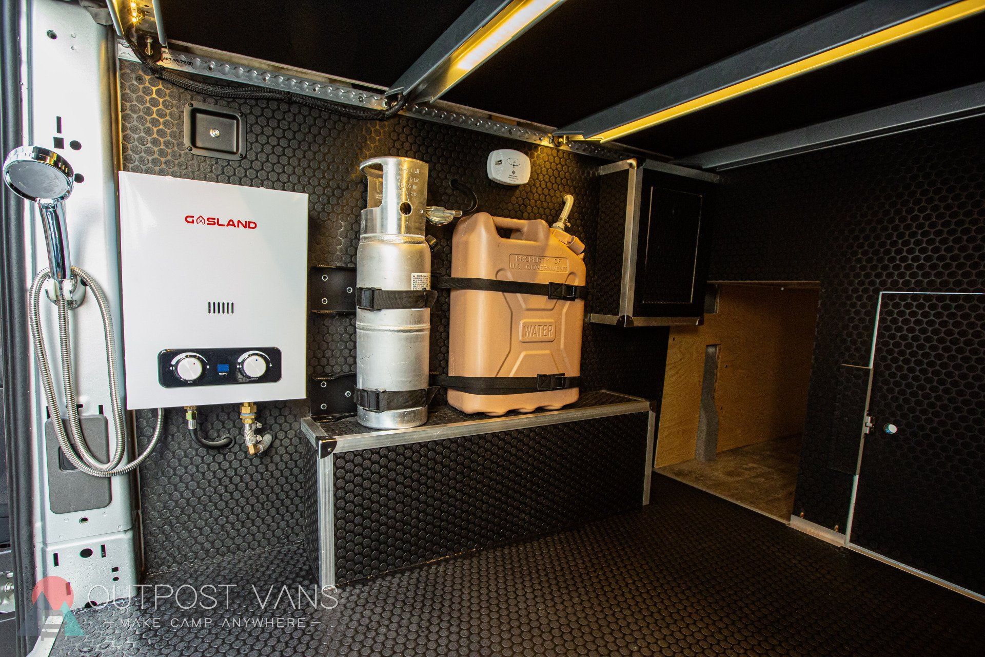 a bathroom in a van with a shower and a heater