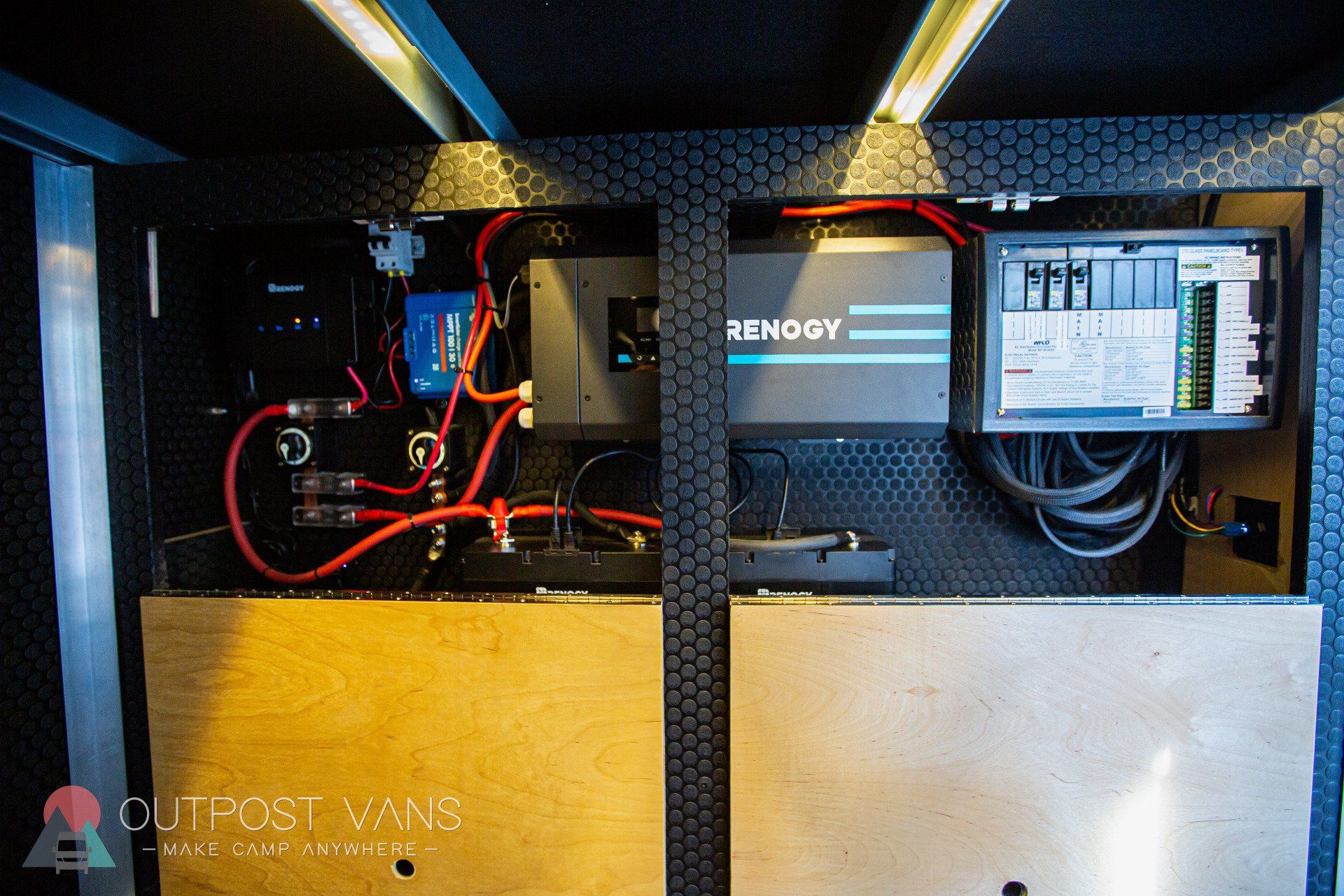 the inside of a van with a bunch of wires coming out of it .