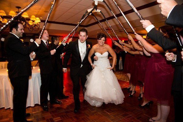 hockey themed grand march at a wedding celebration with Sound Sensations Entertainment and red uplighting