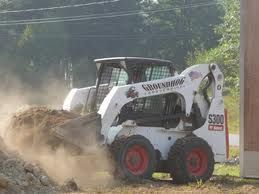 Skid steer spreading in preparation of your sod