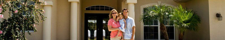 family in front of house