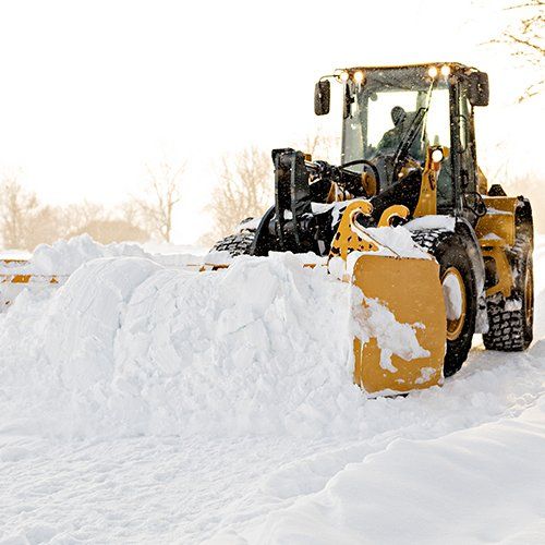 Big Yellow Snow Plow Cleaning a Road — Baldwinsville, NY — Shute Landscaping Big Yellow Snow Plow Cleaning a Road — Baldwinsville, NY — Shute Landscaping