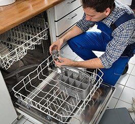 Technician Repairing Dishwasher — Appliance Repair in Wauwatosa, WI Technician Repairing Dishwasher — Appliance Repair in Wauwatosa, WI