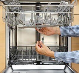 Handyman Repairing A Dishwasher — Appliance Repair in Wauwatosa, WI Handyman Repairing A Dishwasher — Appliance Repair in Wauwatosa, WI