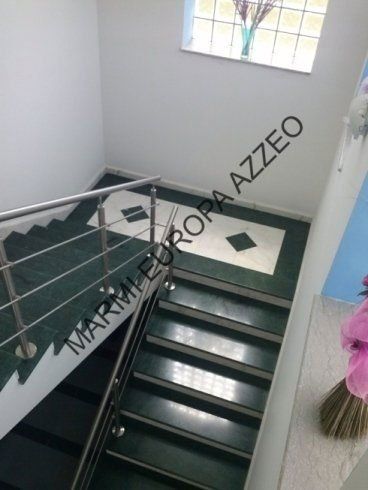 scala in marmo scuro con passamano in acciaio