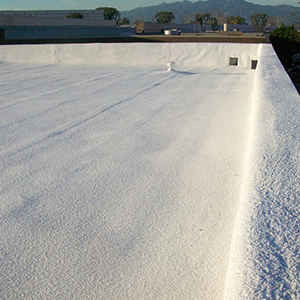 White-coated flat roof. Buildings and mountains visible in background.