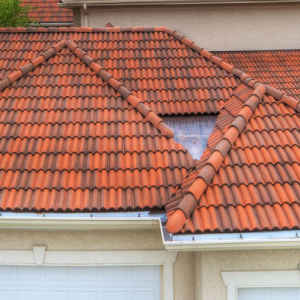 Red clay tile roof with a skylight.