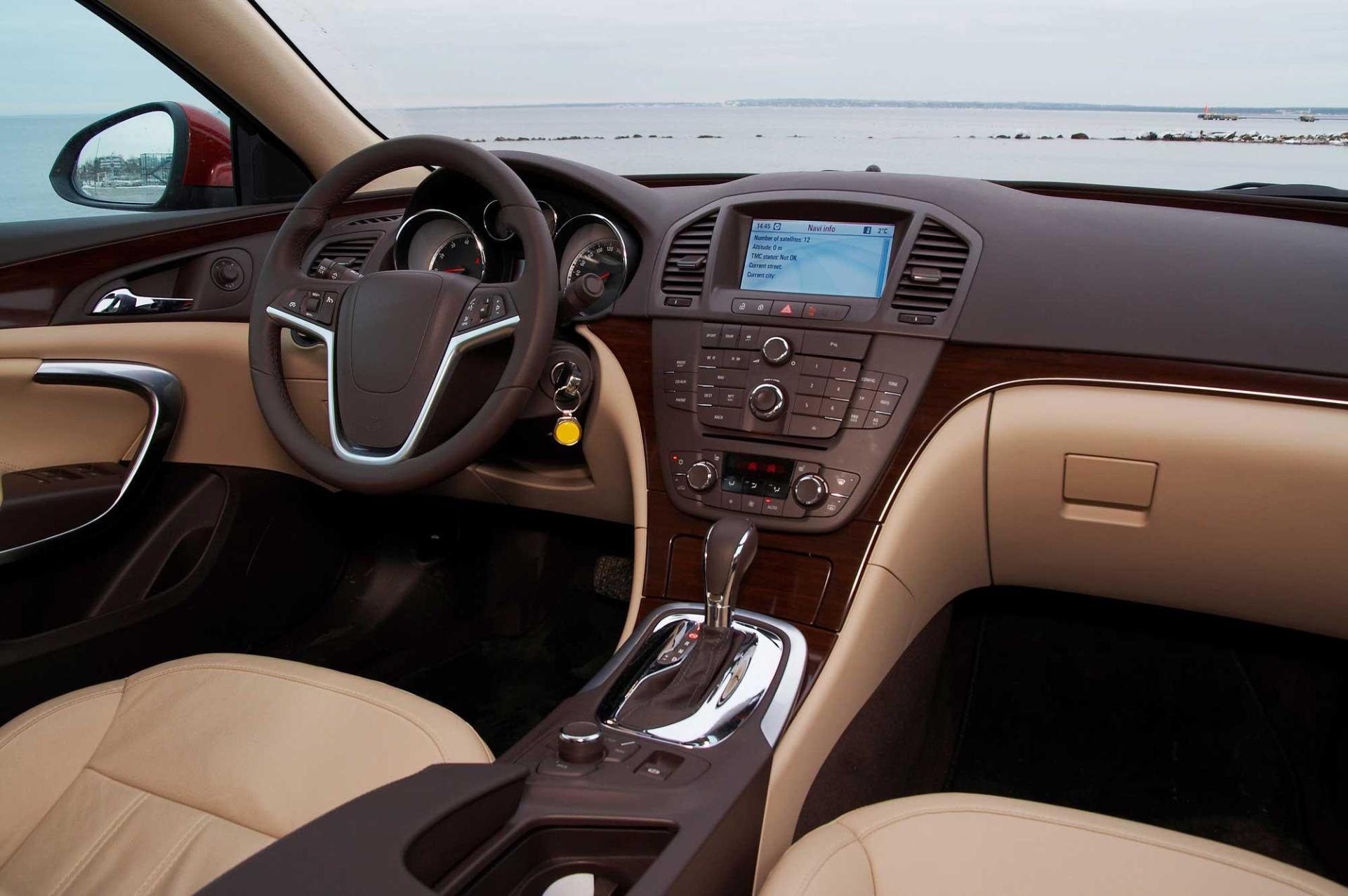 The interior of a car with a steering wheel and dashboard