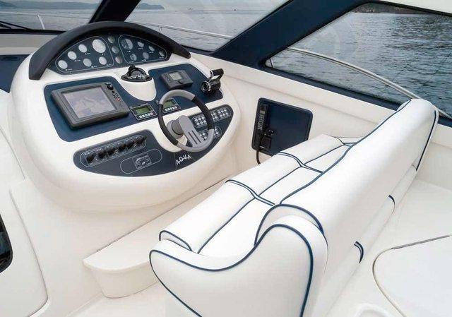 A boat with a steering wheel and a seat