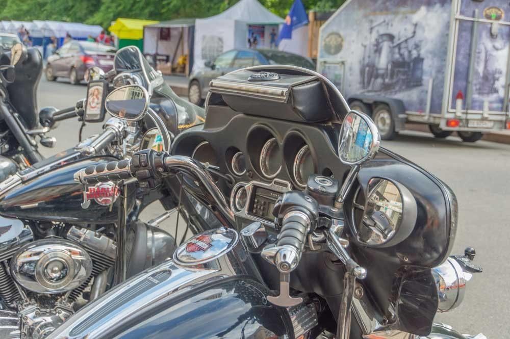 A row of motorcycles are parked on the side of the road.