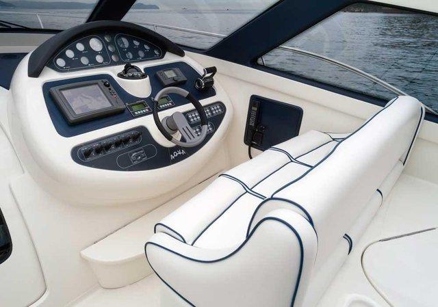 A boat with a steering wheel and a seat