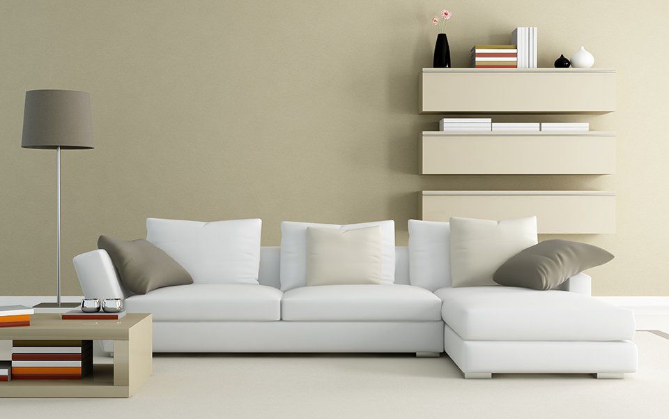 A living area with smooth, cream coloured walls and matching decorative elements