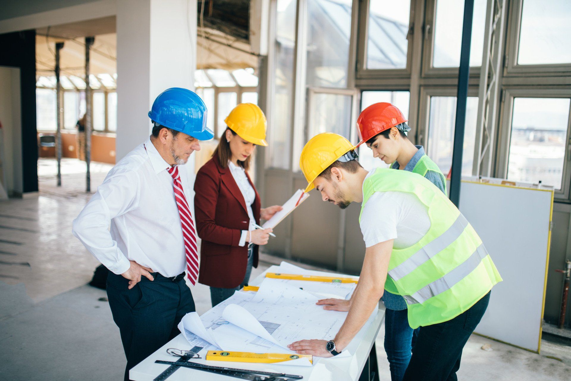 Construction workers and architects working on construction site