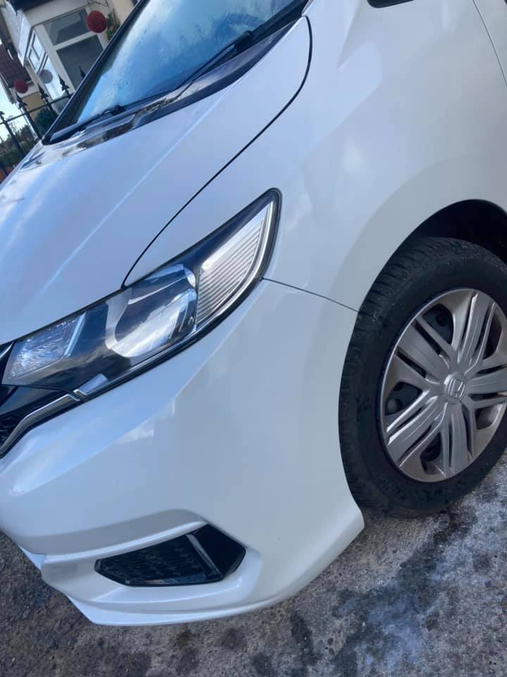 side view of white car
