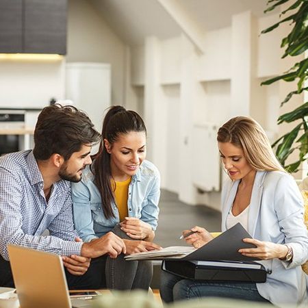 A couple meet with their property manager to go over information