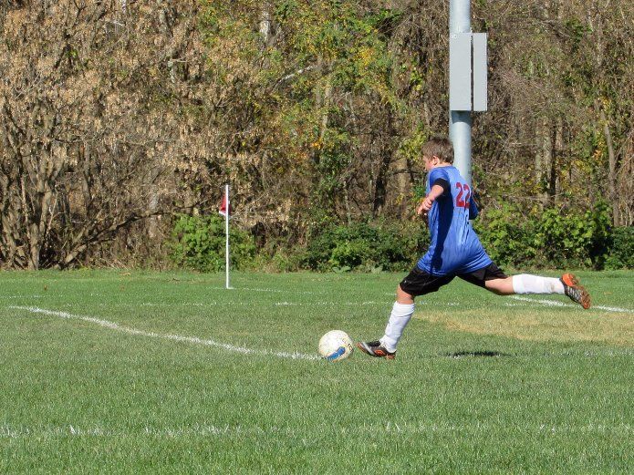 boy playing soccer.