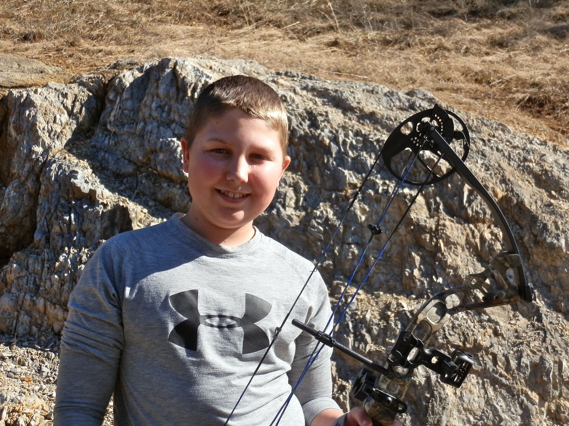 Boy with bow used for hunting.