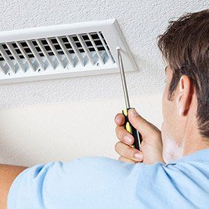 Man Fixing Air Conditioner — St. Louis, MO — Air Rescue