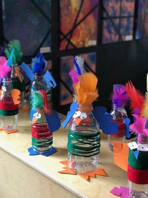 A bunch of water bottles decorated to look like birds