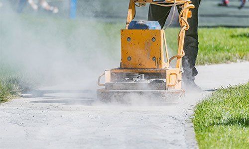 Worker Makes New Narrow Road — Edwardsville, IL — Keller Asphalt & Paving