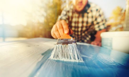man painting wooden board Types of Paint to Use | Ace Paints