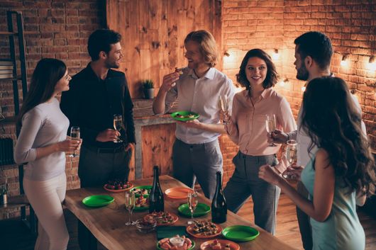 friends eating appetizers around the table How to Protect Your Furniture During Holiday Parties | Ace Paints