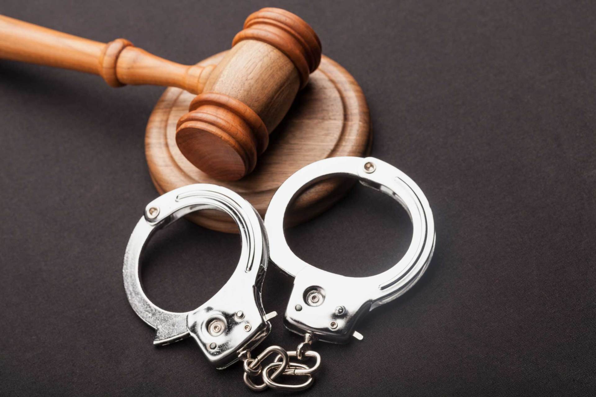 Judge Gavel And Handcuffs On Wooden Desk — Huntsville, AL — Elissa Green Attorney at Law