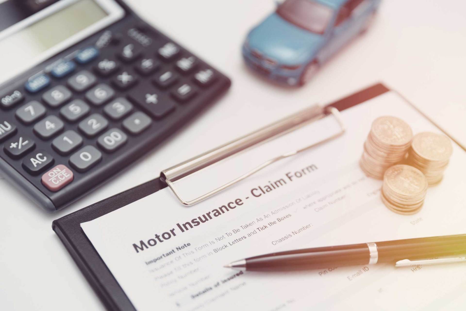 Car Insurance Claim with Coins, Calculator and Car Model — Huntsville, AL — Elissa Green Attorney at Law
