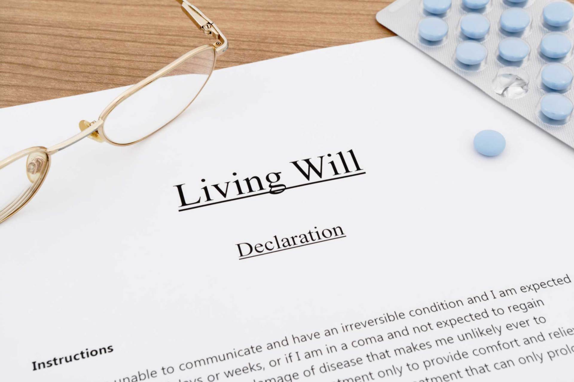 Living Will with Pills and Eyeglasses on Wooden Table — Huntsville, AL — Elissa Green Attorney at Law