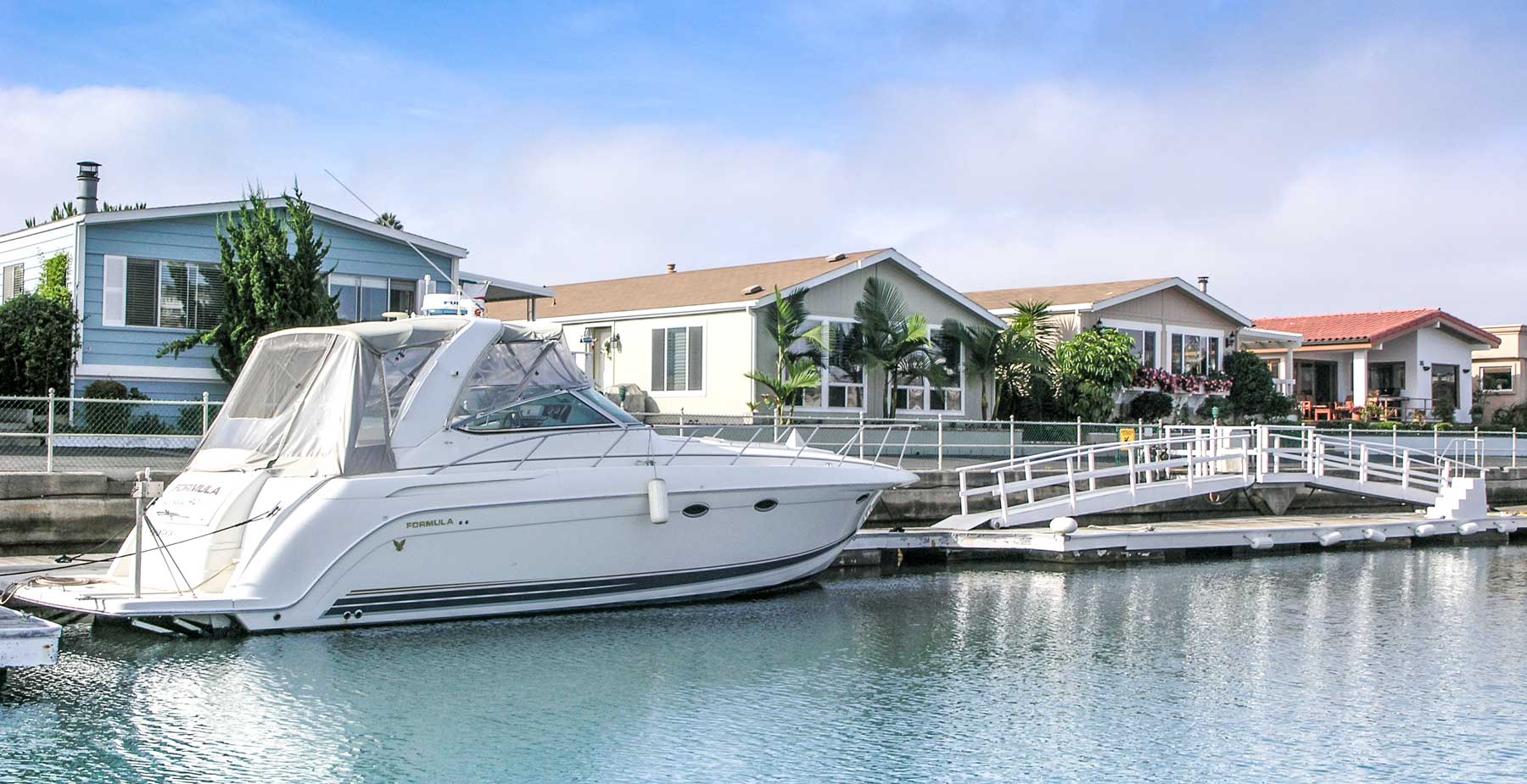 Boat in side tie with Bayside Village homes in background.